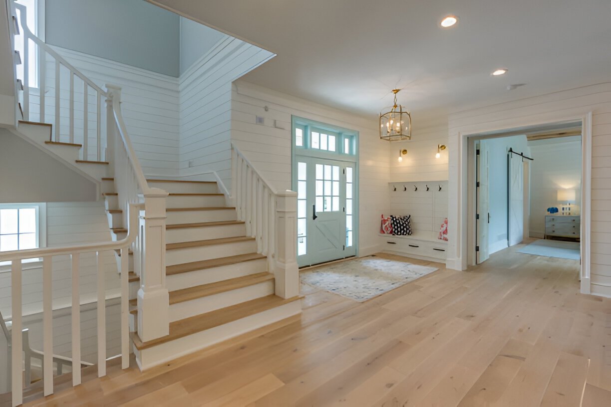 Bright modern foyer with white oak hardwood flooring and staircase
